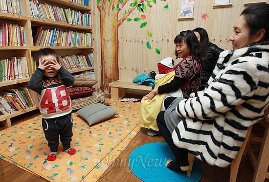 25일 오후 서울 용산구 효창운동장 인근 어린이 도서관 '고래이야기'에서 학부모들이 아이들의 숨바꼭질 놀이를 지켜보며 즐거운 시간을 보내고 있다.