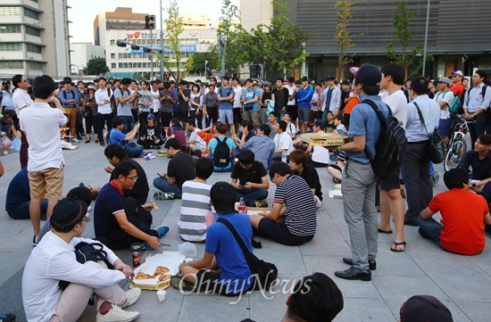 일베 회원등이 세월호 진상규명 특별법 단식농성장 앞에서 '도시락 나들이' 등 먹거리 집회를 예고한 6일 오후 서울 광화문광장 세종대왕상 앞에서 일베 회원들과 시민들이 피자와 치킨을 먹고 있다.