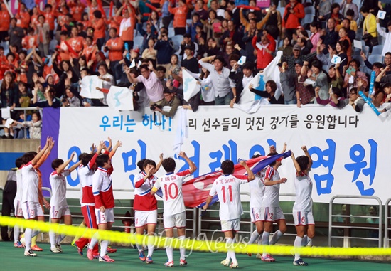 금메달 획득한 북한 여자축구 "우리는 하나다" 북한 여자축구대표팀 선수들이 1일 오후 인천 문학월드컵경기장에서 열린 '2014 인천아시아경기대회' 여자축구 일본과의 결승전에서 3대 1로 승리한 뒤 관중석에 있는 시민들을 찾아가 "우리는 하나다"라고 답례인사를 하고 있다.