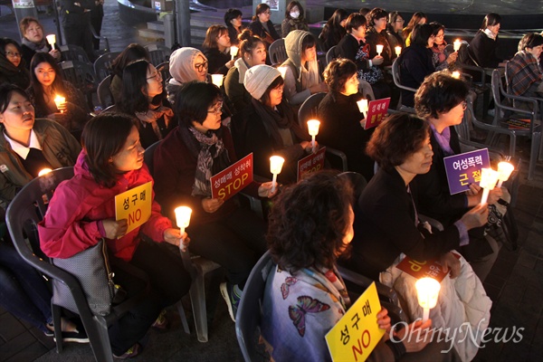 30일 저녁 창원 상남동 분수광장에서 열린 '성구매자에 의한 피살 여성 4주기 추모문화제'에서 참가자들이 촛불을 들고 있다.