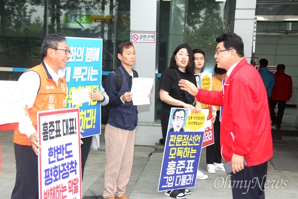  경남진보연합 회원들이 2일 오후 창원컨켄변센터 앞에 홍준표 자유한국당 대표를 비난하는 손팻말을 들고 서 있다.