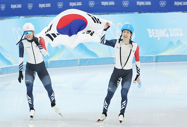정재원(왼쪽)과 이승훈이 19일 중국 베이징 국립 스피드스케이팅 경기장(오벌)에서 열린 2022 베이징 동계올림픽 스피드스케이팅 남자 매스스타트 결승에서 각각 은메달과 동메달을 획득한 뒤 함께 태극기를 들고 관중석을 향해 인사하고 있다. 2022.2.19
