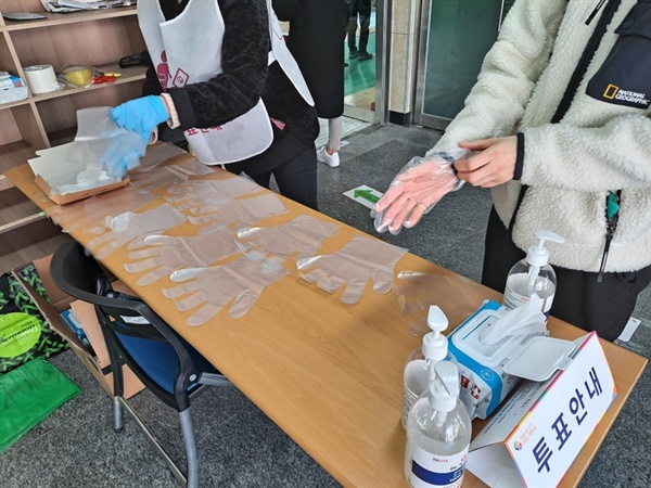 유권자들은 체온을 측정하고 손 소독을 한 후 비닐장갑을 끼고 기표소로 향한다.