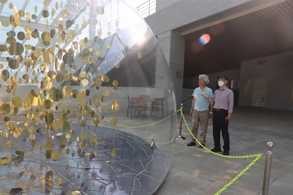 예울마루 7층 전시실 야외 로비 STUDIO 1750의 흥미로운 설치 작품
'반짝이는 living things' 앞에서 한창진씨 (오른쪽) 
