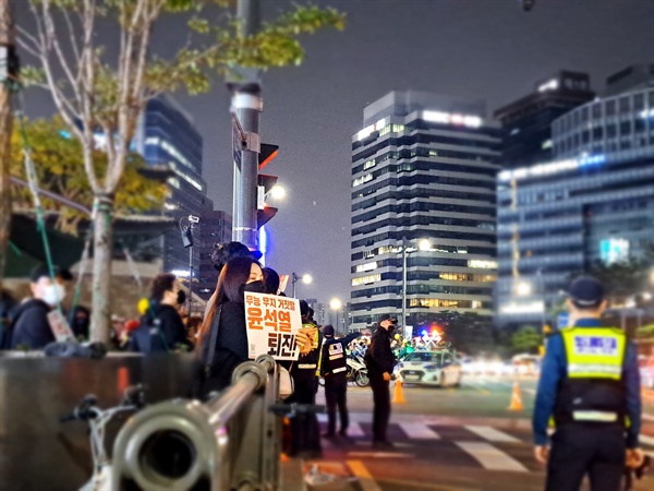 22일 저녁 촛불행동 주최 제11차 촛불대행진이 진행된 서울시청 인근에서 시민들이 피켓을 들고 있다