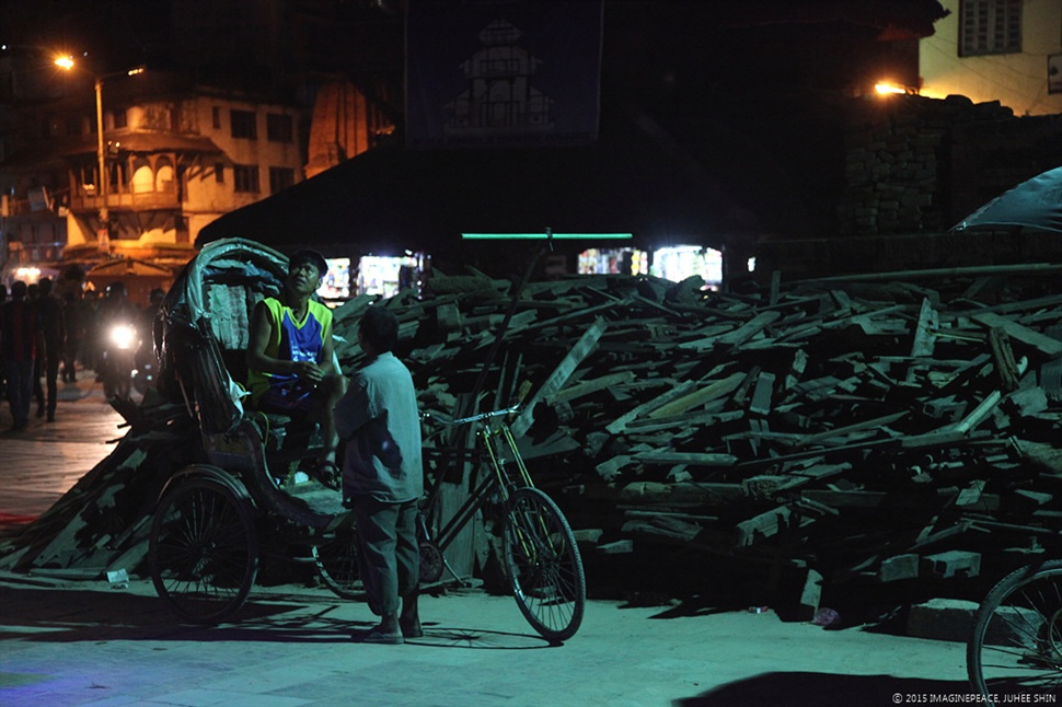  지진 피해가 가장 컸던 유네스코 문화유산지구 덜발광장. 차곡차곡 쌓인 마주 사원(Maju Temple)의 잔해 앞에서 인력거가 손님을 기다리고 있다. 