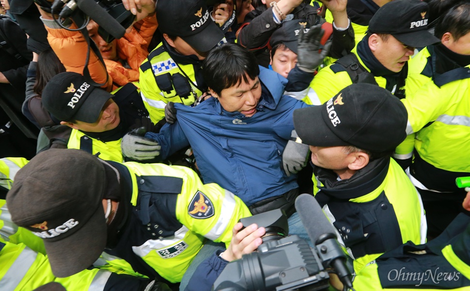사지 붙들려 끌려나오는 조계종 신도 경찰이 9일 오후 서울 종로구 조계사에서 한상균 민주노총 위원장이 은신하고 있는 관음전 진입을 시도하며 경내 진입을 막는 조계종단 관계자를 끌어내고 있다.