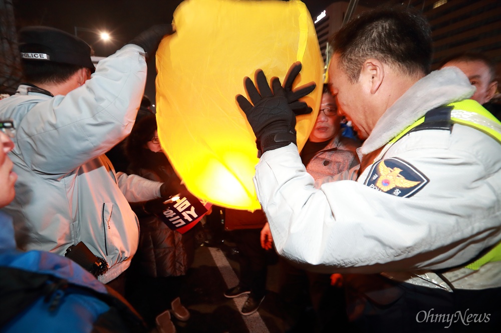 광화문광장 '풍등' 제지하는 경찰 31일 오후 광화문광장에서 열린 박근혜 즉각퇴진을 위한 ‘송박영신’ 10차 범국민행동의 날 행사에서 일부 시민들이 ‘풍등’을 날리려 하자 경찰이 화재위험이 있다며 제지하고 있다.