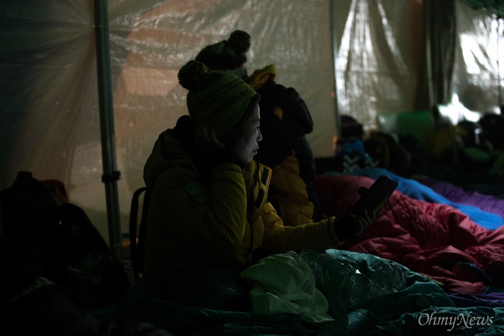  인양된 세월호가 목포신항으로 도착한 31일 오후 전남 목포 목포신항 입구 앞에 설치한 임시천막에서 잠을 자기 위한 준비를 하고 있다. 