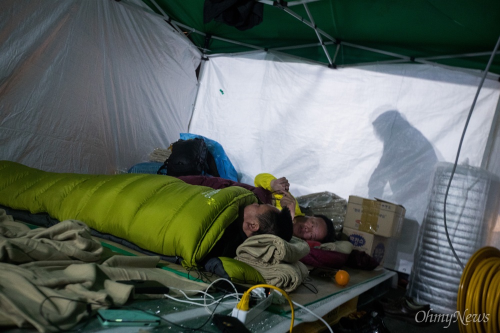  인양된 세월호가 목포신항으로 도착한 31일 오후 전남 목포 목포신항 입구 앞에 설치한 임시천막에서 잠을 자기 위한 준비를 하고 있다. 