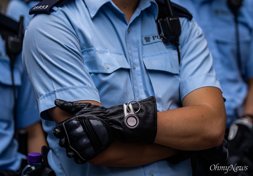  17일 오전 범죄인 인도법(일명 송환법) 폐지를 촉구하는 ‘검은 행진’에 참가한 홍콩 시민들에게 경찰들이 도로점거 철수를 요구하며 대치하고 있다.