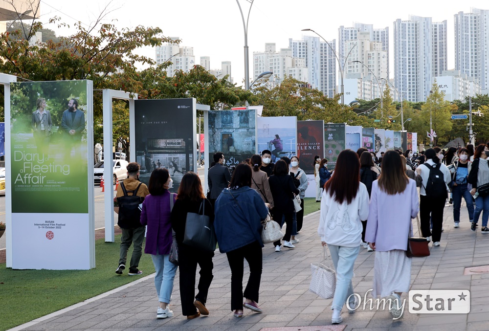  제27회 부산국제영화제 개막식이 열릴 5일 오후 부산 해운대구 영화의전당에서 시민들이 영화제 포스터를 둘러보고 있다.