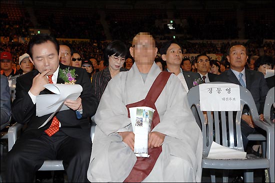 이명박 대선 후보가 다음 행사일정으로 자리를 떠나자 이명박 후보가 앉아있던 의자에 한 스님이 앉아있다.