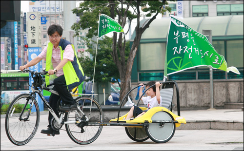 자전거도시 만들기 캠페인 참가한 아버지와 아들이 자전거도시 만들기 운동본부 캠페인에 앞서 부평역 앞을 돌고 있다.