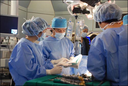 수술 장면 촬영에 앞서 배우 조재현이 김숭양 간호사와 함께 대본을 점검하고 있다. 
