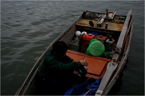 배에 오른 어부는 전등을 점검하고 바다로 떠날 채비를 합니다.