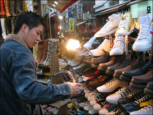 신발을 고르고 있는 동생의 모습. 군인다운 흥정으로 아주 만족할 만한 가격에 신발을 구매했다.