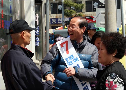 최연희 후보 시장에서 만난 사람과 반갑게 인사하고 있다.