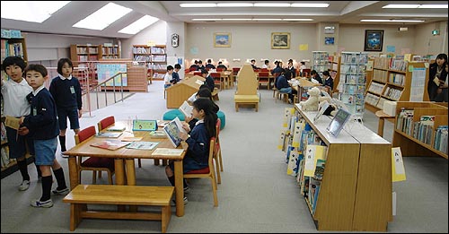 도쿄 소카초등학교 로망도서관에서 학생들이 자유롭게 책을 읽고 있는 장면.