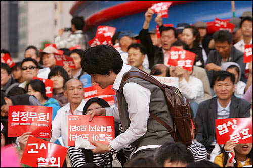 광우병 위험으로부터 안전하지 않은 미국산 쇠고기 수입에 반대하는 학생과 시민들이 17일 저녁 서울 청계광장에서 재협상을 촉구하며 촛불문화제를 열고 있다. 교복을 입은 한 학생이 문화제에 참여하고 있다. 