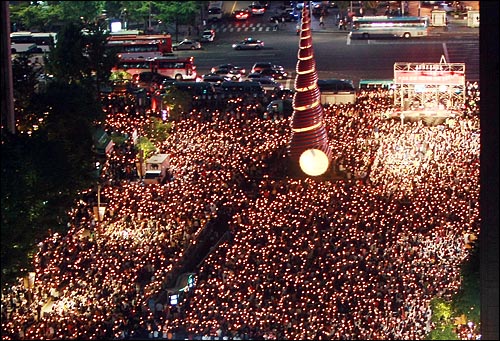 미국산 쇠고기 수입 전면 개방을 반대하는 학생과 시민들이 17일 저녁 서울 청계광장에서 열린 '5.17 미친소, 미친교육, 촛불문화제'에서 정부의 미국산 쇠고기 수입 정책 철회를 촉구하며 촛불을 들고 있다.