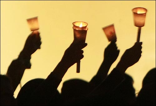 미국산 쇠고기 수입 전면 개방을 반대하는 학생과 시민들이 지난 17일 저녁 서울 청계광장에서 열린 '5.17 미친소, 미친교육, 촛불문화제'에서 정부의 미국산 쇠고기 수입 정책 철회를 촉구하며 촛불을 들고 있다. 