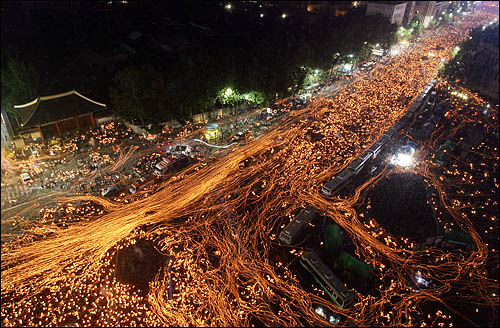 6.10 항쟁 기념일인 지난 2008년 6월 10일 서울 세종로 광화문 일대에서 미국산 쇠고기 수입에 반대하는 학생과 시민들이 전면 재협상을 촉구하며 촛불 행진을 하고 있다. 당시 주최쪽은 집회 참여인원을 50만 명, 경찰은 10만 명으로 추산했다. 경찰 추산 인원은 정확한 유동 인원을 따지지 못하는 한계가 있다.