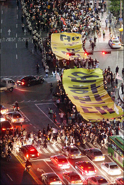 미국산 쇠고기 수입과 대운하 건설에 반대하는 시민들이 17일 저녁 서울시청 앞 광장에서 촛불집회를 연 뒤 '대운하반대' 대형 플래카드를 들고 거리행진을 하고 있다.