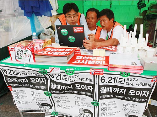 이명박 대통령의 미국산 쇠고기 수입문제에 관련한 특별 기자회견을 한 19일 오후 서울 시청광장 앞에 설치된 광우병국민대책회의 상황실에서 자원봉사자들이 노트북으로 특별 기자회견 기사를 검색하고 있다.