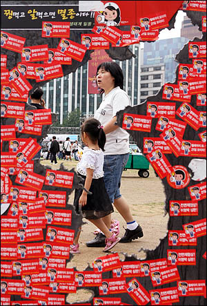 '48시간 비상국민행동' 둘째 날인 21일 오후 서울시청 앞 광장에 전시된 설치미술가 최병수씨의 작품 너머로 참가자들이 속속 모이고 있다.