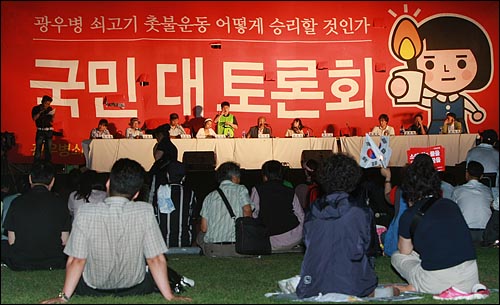 학생과 시민들이 24일 밤 서울 시청 앞 광장에서 광우병국민대책회의 주최로 열린 '광우병쇠고기 촛불운동 어떻게 승리할 것인가' 제2차 국민대토론회를 지켜보고 있다.