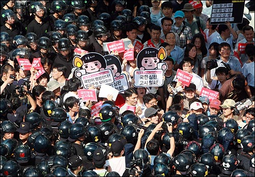 지난 2008년 6월 25일 오후 서울 광화문 경복궁역 앞에서 학생과 시민들이 경찰들에게 에워싸여 미국산 쇠고기 관련 장관고시 철회와 전면 재협상을 요구하고 있다.