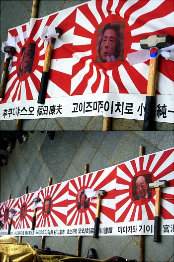 일본의 전·현직 총리 사진들이 길가에 놓여 있다.