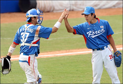  한국의 윤석민이 18일 베이징 우커송 야구장에서 열린 2008베이징올림픽 야구 예선 대만과의 경기에서 9대8로 승리한 뒤 강민호와 하이파이브를 하고 있다.