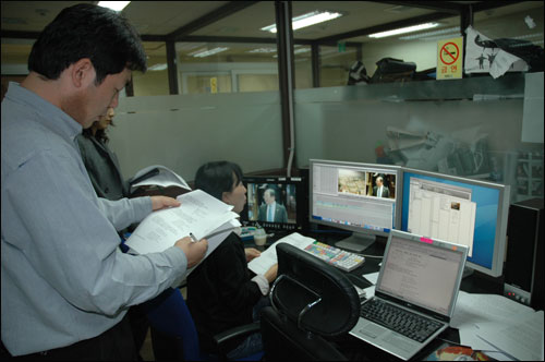 13일 밤 11시 30분께, KBS 신관 808 편집실에서 최필곤 PD(맨 왼쪽)와 이명우 PD(앉아있는 이)가 편집에 열중하고 있다.