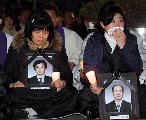  지난 2월 24일 저녁 서울 종로구 동화면세점 앞에서 열린 '용산철거민 참사 추모와 이명박정권 1년평가와 반민주악법 저지와 대북정책을 위한 시국기도회'에서 용산철거민참사 유가족이 손수건으로 눈물을 훔치고 있다. 왼쪽에 앉아있는 사람이 고 윤용헌씨 부인 유영숙씨.