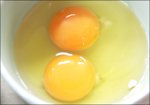 김아무개씨가 6일 가게에서 구입한 계란 2개를 깬 것으로, 이 계란 속에서는 노른자위가 각각 1개씩 나왔다.