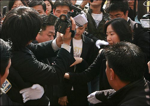  세계피겨선수권대회에서 우승한 김연아 선수가 2일 오전 고려대 체육교육과에 입학한 뒤 처음으로 학교를 방문한 뒤, 총장 면담을 위해 본관에 도착하고 있다. 포토라인이 무너지면서 카메라 기자들이 김연아 선수 주변으로 몰려들자 김 선수가 놀란 표정으로 움츠리고 있다.