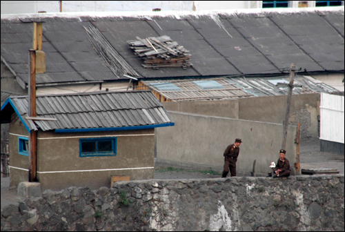 북한 양강도 중부 압록강 연안에 있는 혜산시에 있는 한 경비초소와 군인 2명이 나와 이야기를 나누는 모습이다.