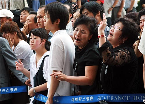 고 김대중 전 대통령의 운구 차량 행렬을 지켜보던 시민들이 오열하고 있다.