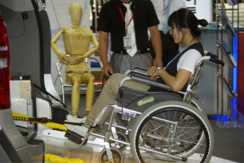 자동리프트로 차에 오르는 휠체어 탑승자.
