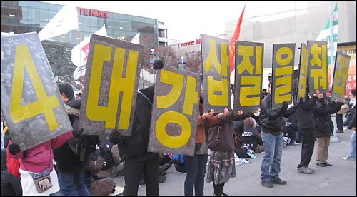 지난 21일 서울역 광장에서 열린 '12월 공동행동 선포식'에서 참가자들이 4대강 사업 중단을 요구하는 퍼포먼스를 벌이고 있다.