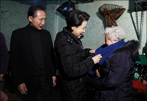 지난 12일 이른바 욕쟁이 할머니 식당을 방문한 이명박 대통령과 부인 김윤옥씨가 할머니에게 목도리를 선물하고 있다. 