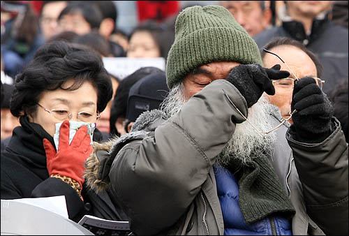 2010년 1월 9일 오후 서울역광장에서 열린 용산참사 희생자 영결식에 참석한 문정현 신부가 눈물을 훔치고 있다. 왼쪽은 한명숙 전 총리.