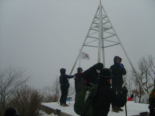 산 정상을 덮은 시멘트와 철제구조물 태극기를 세운 국기게양대를 지탱하기 위해 바닥에 콘크리트로 칠갑을 했다.