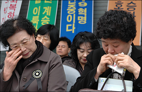 김주열 열사의 범국민장이 50년만인 11일 마산 중앙부두에서 열린 가운데, 큰 누나 영자씨와 작은 누나 경자씨가 눈시울을 붉히고 있다.