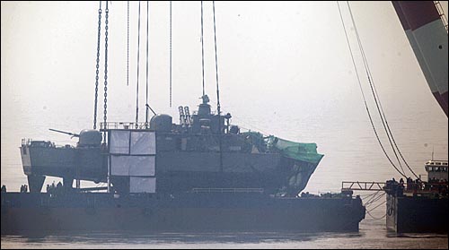 천안함 침몰 20일째인 지난달 15일 오후 백령도 장촌포 함미 인양해역에서 천안함 함미부분이 해상크레인에 의해 바지선 위에 실려있다.