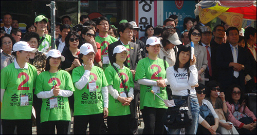 많은 선거운동원과 지지자들이 송 후보의 유세 현장을 지켜보고 있다. 