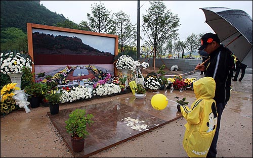  고 노무현 전 대통령 서거 1주기를 맞은 23일 오전 경남 김해시 봉하마을 노 전 대통령 묘역을 찾은 추모객들이 고인의 넋을 기리고 있다.