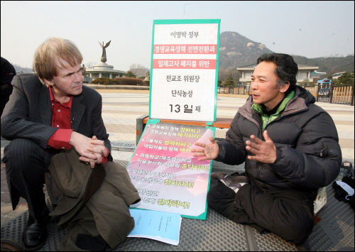 지난 3월 9일 세계교원단체총연맹  프레트 판 레이우언(Fred Van Leeuwen) 사무총장(왼쪽)이 청와대 앞에서 단식농성 중인 정진후 전교조 위원방을 방문, 지지의 뜻을 전하고 있다.
